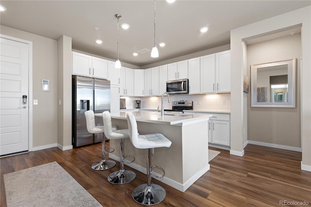 kitchen with stainless steel appliances, baseboards, decorative backsplash, light countertops, and recessed lighting
