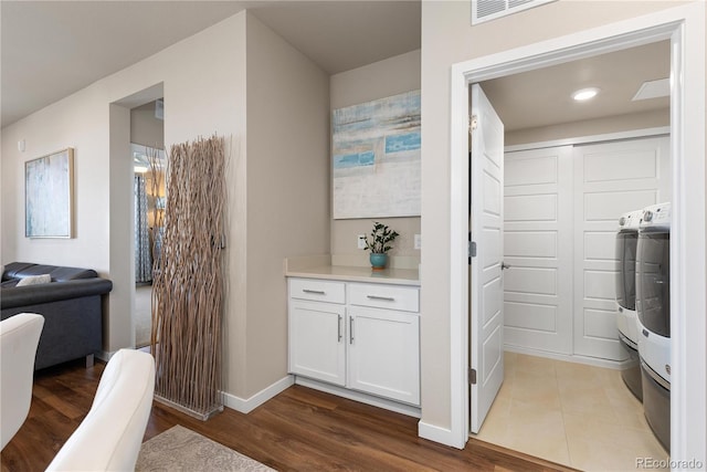 corridor with dark wood-type flooring, baseboards, and recessed lighting