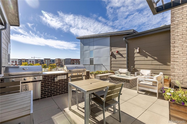 view of patio / terrace featuring exterior kitchen, area for grilling, and outdoor dining area