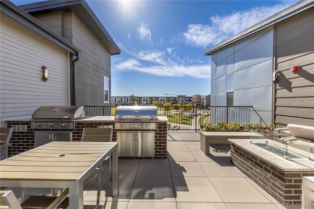 view of patio featuring area for grilling, outdoor dining space, and an outdoor kitchen