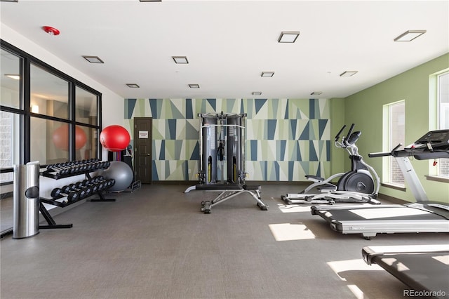 gym featuring wallpapered walls