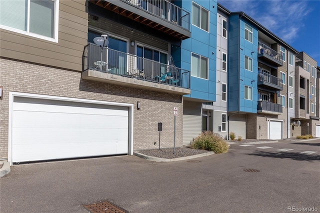view of apartment building / complex with an attached garage