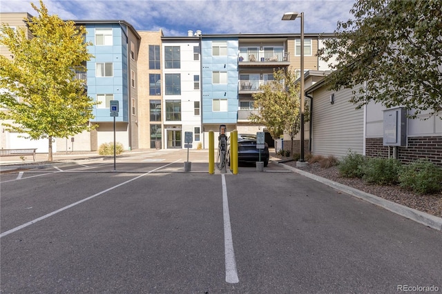 view of building exterior featuring uncovered parking