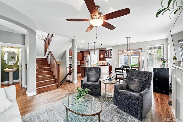3644 Wabash St, Denver, CO 80238 - living area featuring a ceiling fan, stairs, light wood-type flooring, and baseboards