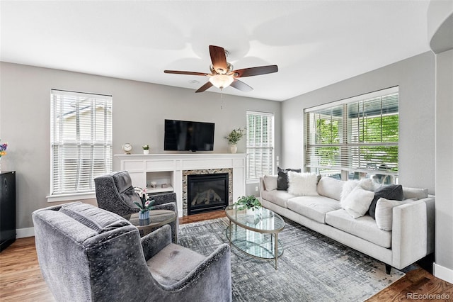 3644 Wabash St, Denver, CO 80238 - living area featuring wood finished floors, plenty of natural light, ceiling fan, and baseboards