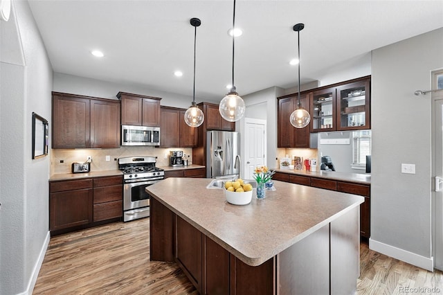 3644 Wabash St, Denver, CO 80238 - kitchen with stainless steel appliances, baseboards, light wood-style floors, dark brown cabinets, and recessed lighting