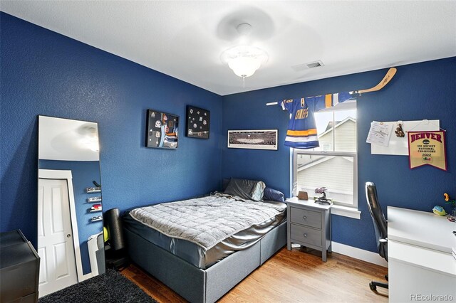 3644 Wabash St, Denver, CO 80238 - bedroom featuring wood finished floors, a textured wall, an office area, and baseboards