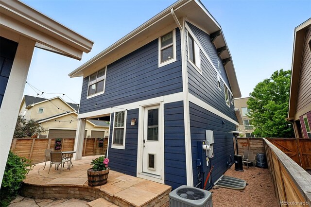 3644 Wabash St, Denver, CO 80238 - rear view of house featuring central air condition unit, a patio, and a fenced backyard