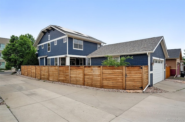 3644 Wabash St, Denver, CO 80238 - view of front of house featuring a shingled roof and an attached garage