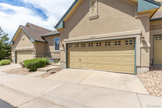 view of front of home with driveway and stucco siding