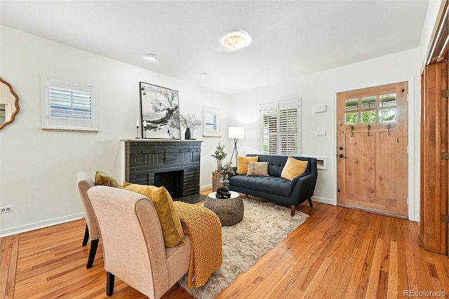 554 S Logan St, Denver, CO 80209 - living room featuring a brick fireplace and light wood-style flooring
