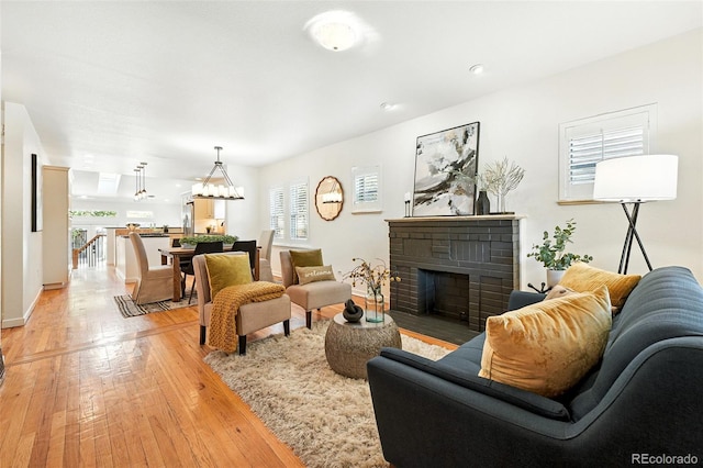 554 S Logan St, Denver, CO 80209 - living room with plenty of natural light, a fireplace, and light wood-type flooring