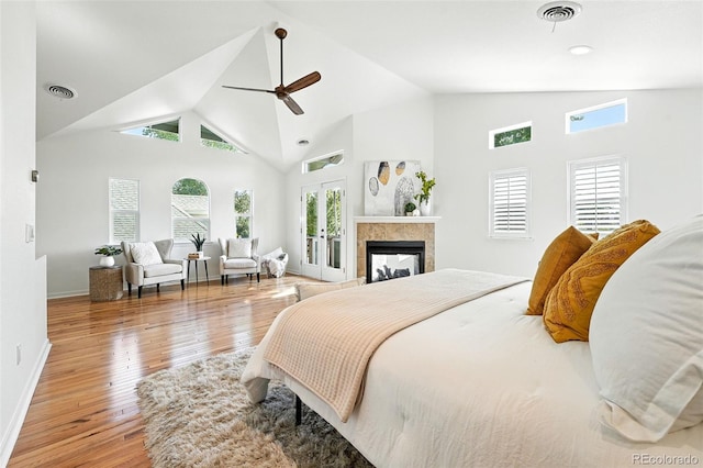 554 S Logan St, Denver, CO 80209 - bedroom with hardwood / wood-style flooring, access to exterior, a fireplace, high vaulted ceiling, and a ceiling fan