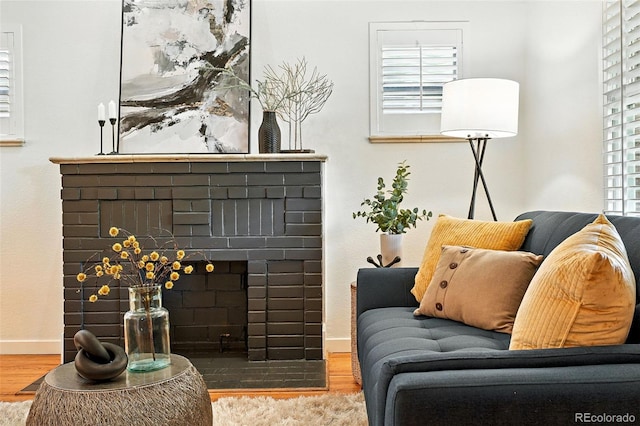 554 S Logan St, Denver, CO 80209 - living area with wood finished floors and a brick fireplace