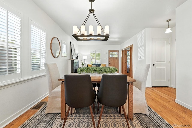 554 S Logan St, Denver, CO 80209 - dining room featuring wood finished floors and a chandelier