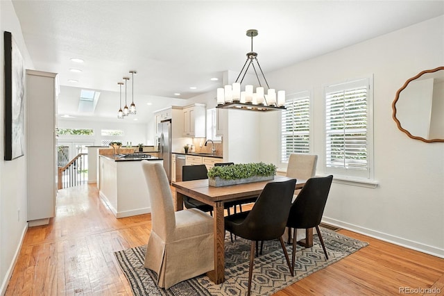 554 S Logan St, Denver, CO 80209 - dining area featuring a chandelier, light wood-type flooring, and recessed lighting