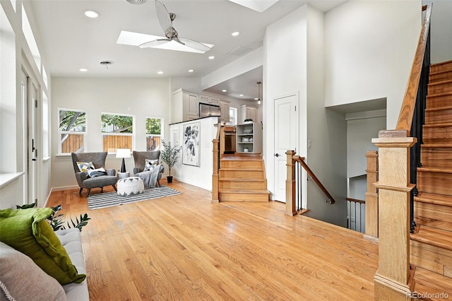 554 S Logan St, Denver, CO 80209 - living room featuring a skylight, light wood-style floors, recessed lighting, stairway, and a ceiling fan