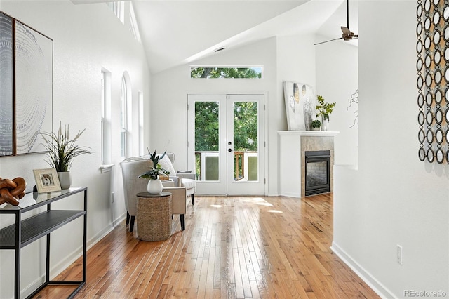 554 S Logan St, Denver, CO 80209 - entrance foyer featuring lofted ceiling, light wood-style floors, ceiling fan, a fireplace, and french doors