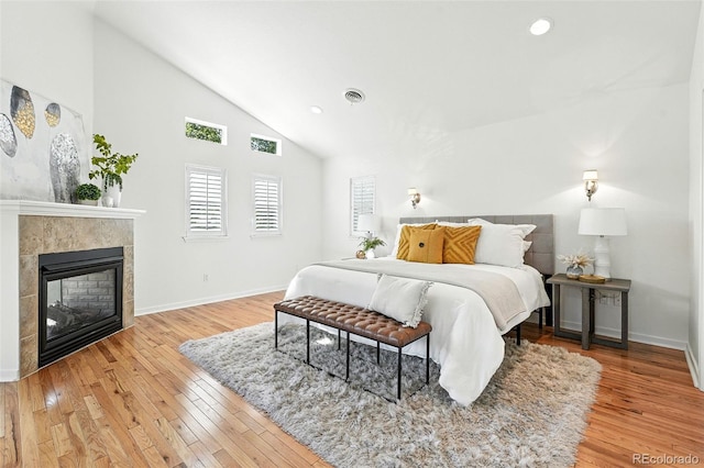 554 S Logan St, Denver, CO 80209 - bedroom with light wood-style flooring, high vaulted ceiling, a fireplace, and recessed lighting