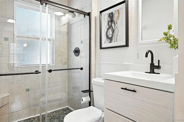 554 S Logan St, Denver, CO 80209 - bathroom with vanity, a shower stall, and wainscoting