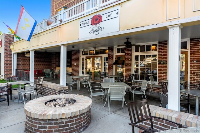 554 S Logan St, Denver, CO 80209 - view of patio / terrace with a fire pit, outdoor dining area, ceiling fan, and french doors