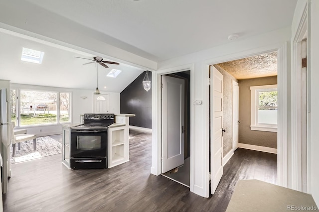 1115 W Quincy Ave, Englewood, CO 80110 - kitchen with black electric range, a skylight, baseboards, a ceiling fan, and vaulted ceiling