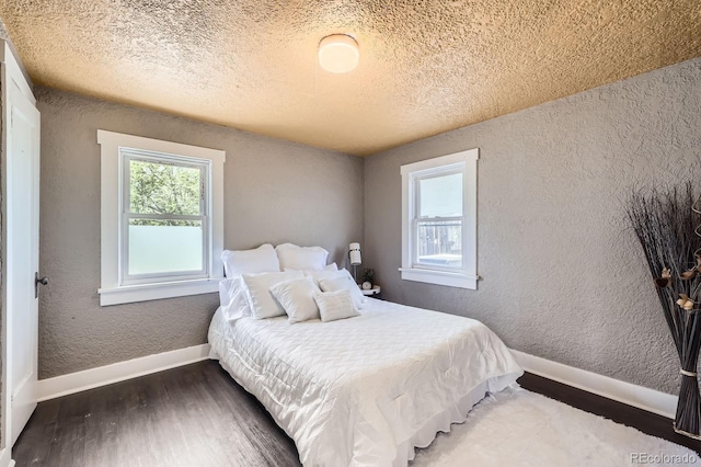 1115 W Quincy Ave, Englewood, CO 80110 - bedroom with a textured wall, a textured ceiling, wood finished floors, and baseboards