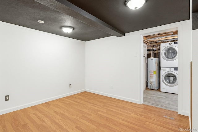 1115 W Quincy Ave, Englewood, CO 80110 - laundry room featuring stacked washer and clothes dryer, water heater, wood finished floors, and baseboards
