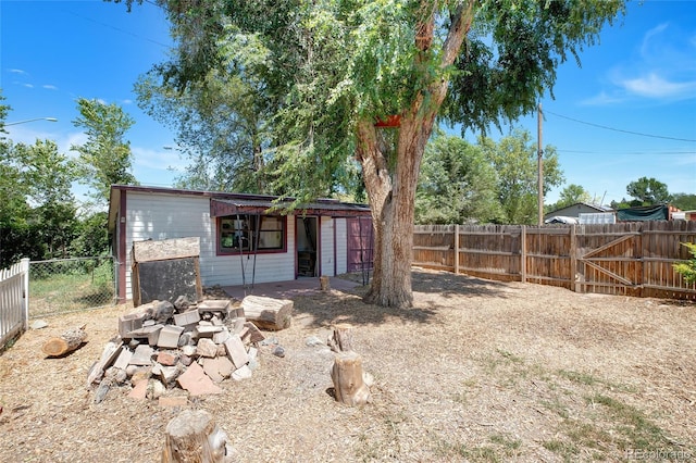 1115 W Quincy Ave, Englewood, CO 80110 - view of front of house with a fenced backyard and an outdoor structure