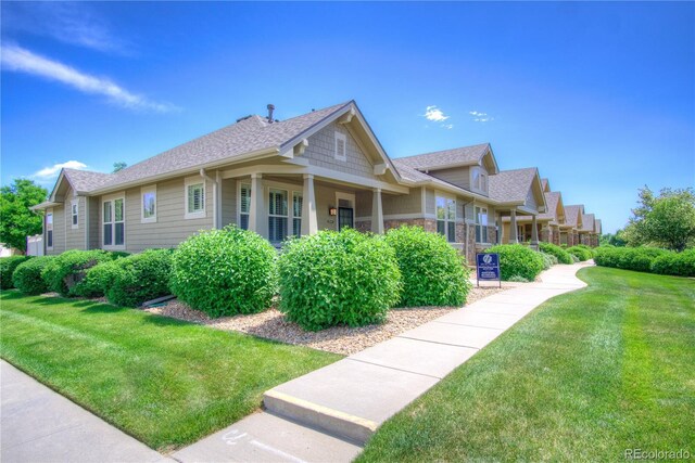 8594 W Quarto Ave, Littleton, CO 80128 - view of property exterior featuring a lawn and roof with shingles