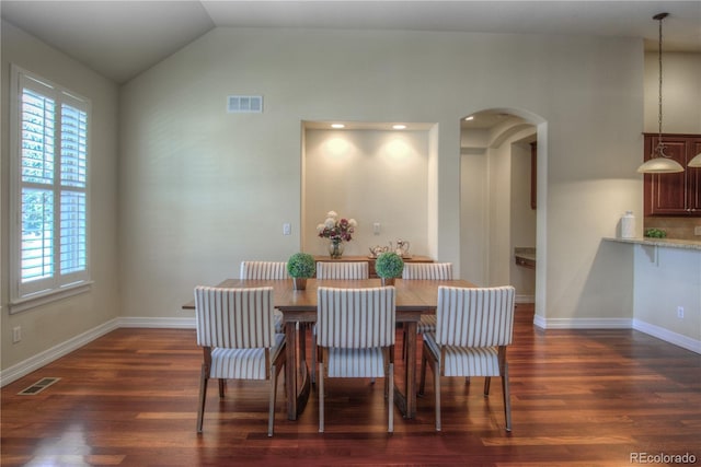 8594 W Quarto Ave, Littleton, CO 80128 - dining space with arched walkways, plenty of natural light, dark wood-style floors, and lofted ceiling