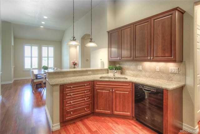 8594 W Quarto Ave, Littleton, CO 80128 - kitchen featuring dishwasher, light wood finished floors, light stone countertops, vaulted ceiling, and a peninsula