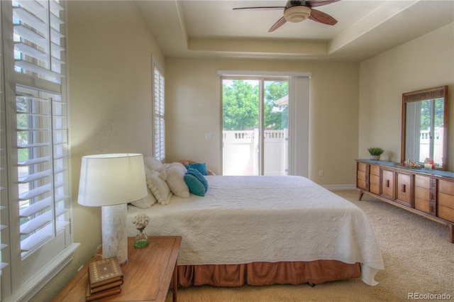 8594 W Quarto Ave, Littleton, CO 80128 - carpeted bedroom with access to exterior, a raised ceiling, and ceiling fan