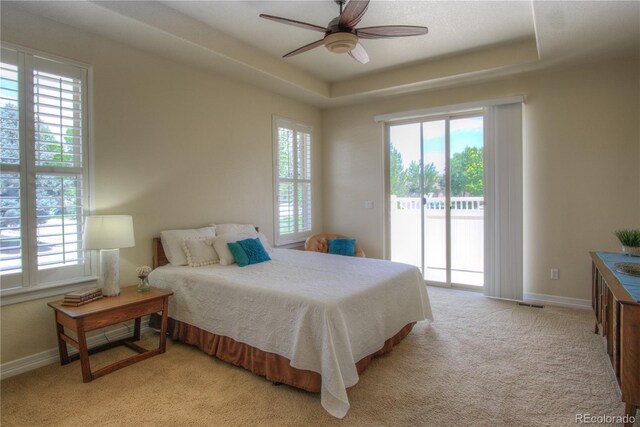 8594 W Quarto Ave, Littleton, CO 80128 - bedroom with access to outside, carpet flooring, a tray ceiling, and ceiling fan