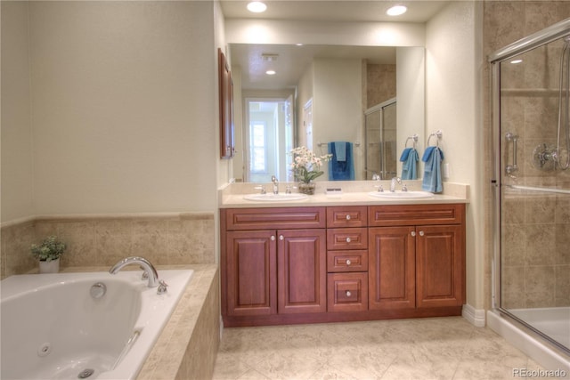 8594 W Quarto Ave, Littleton, CO 80128 - bathroom featuring a tub with jets, a stall shower, double vanity, and tile patterned flooring