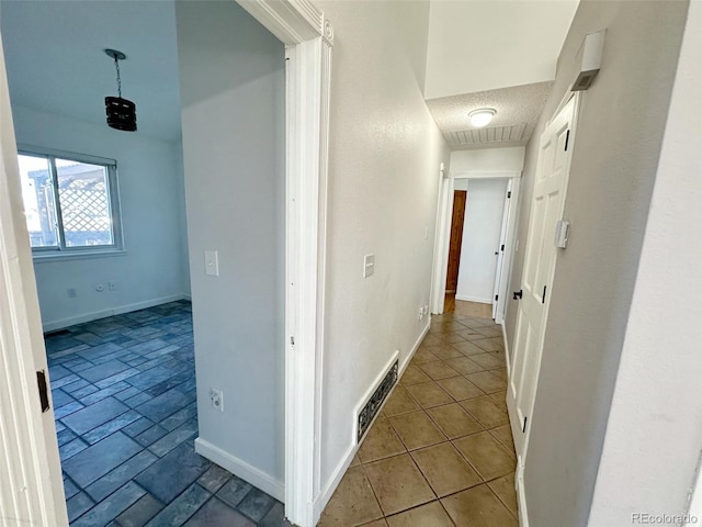 hall featuring a textured ceiling