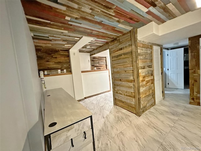 hallway featuring wooden ceiling and wood walls