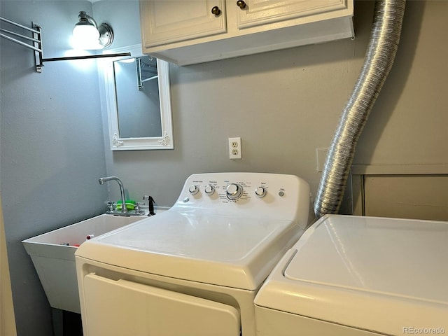 laundry room featuring cabinets and washing machine and clothes dryer