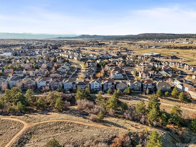 aerial overview of property's location with nearby suburban area and a mountainous background