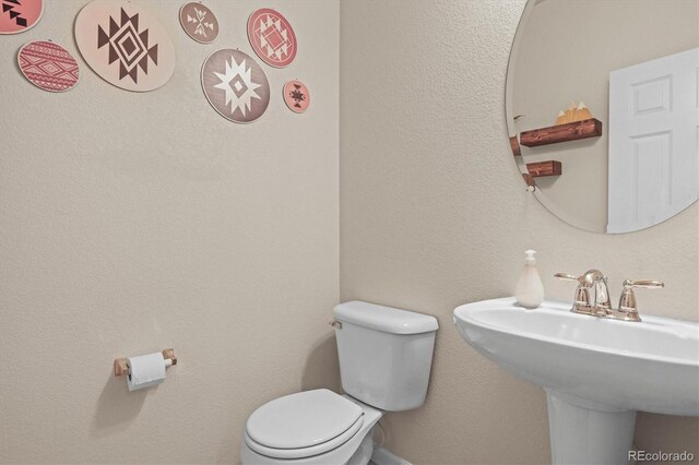 bathroom featuring toilet and a sink