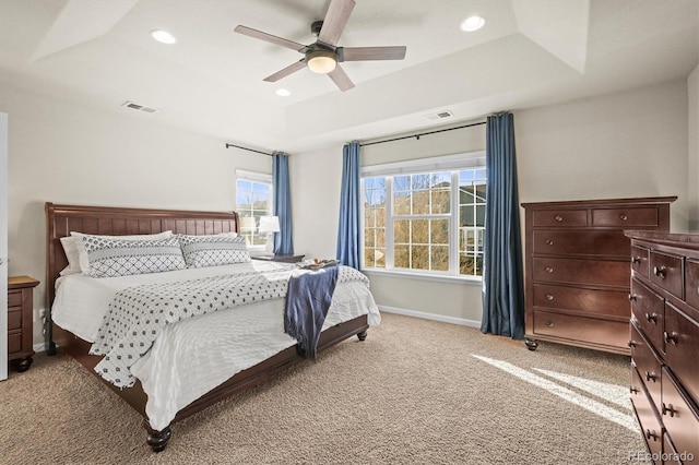 bedroom featuring a raised ceiling, light colored carpet, ceiling fan, baseboards, and recessed lighting
