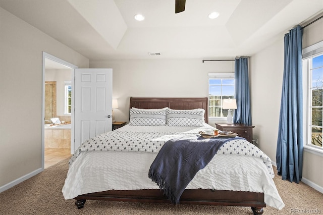 bedroom with a raised ceiling, carpet, multiple windows, and recessed lighting