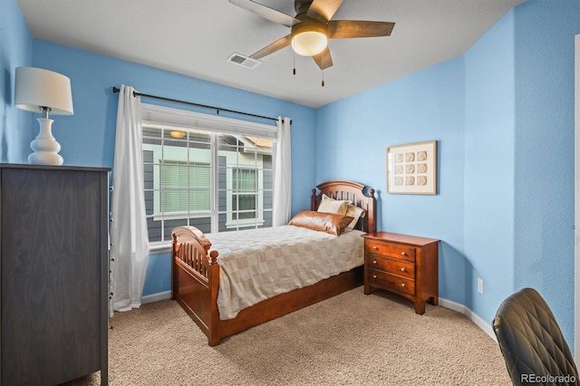 carpeted bedroom featuring baseboards and ceiling fan