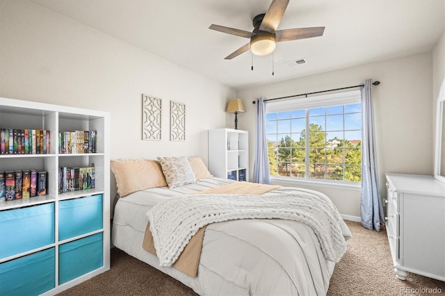 carpeted bedroom featuring baseboards and ceiling fan