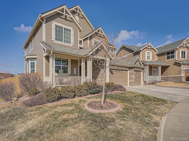 craftsman-style house with an attached garage, covered porch, concrete driveway, and a front yard