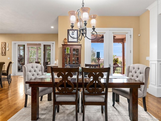 dining room featuring light wood-style flooring and an inviting chandelier