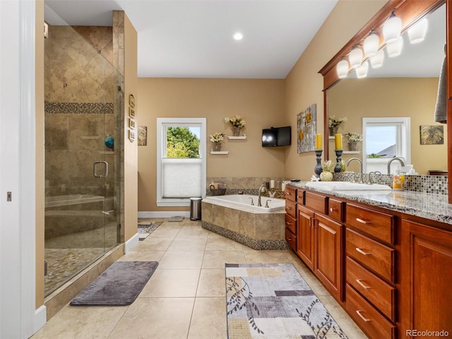 full bathroom with tile patterned flooring, a shower stall, baseboards, a bath, and vanity