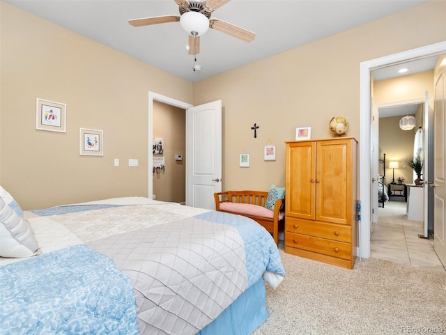 bedroom with light carpet and a ceiling fan