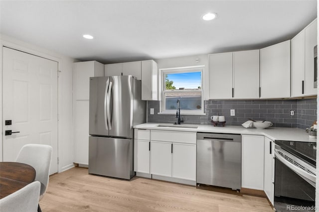 5640 Niagara St, Commerce City, CO 80022 - kitchen with stainless steel appliances, light countertops, decorative backsplash, light wood-style floors, and recessed lighting