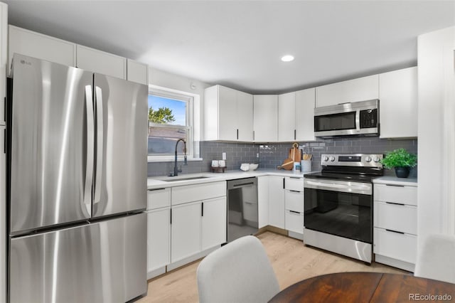 5640 Niagara St, Commerce City, CO 80022 - kitchen featuring appliances with stainless steel finishes, light wood finished floors, light countertops, decorative backsplash, and recessed lighting